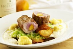 Pork fillet stuffed with apricot on cabbage with dumplings