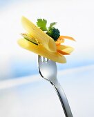 Penne with pieces of vegetables on a fork