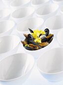 Mussels in a bowl among empty shells