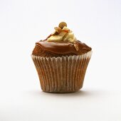 Chocolate banana muffin with caramel frosting and hazelnut