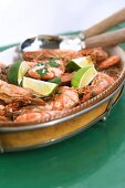 Cooked shrimps with sea salt and lime wedges