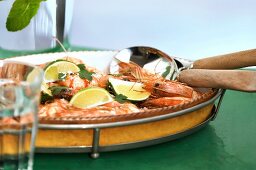 Cooked shrimps with sea salt and lime wedges