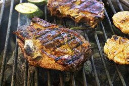 Pork chops and garlic on barbecue