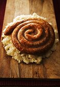 Fried Cumberland sausage on mashed potato