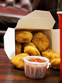Chicken Nuggets in a Take-Out Box with Ketchup