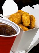 Chicken Nuggets in a Take-Out Box with a Cup of Cola