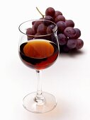 Glass of Red Wine with Red Grapes