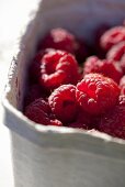 Fresh raspberries in a cardboard box (close-up)