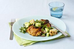 Grilled Chicken Thigh Topped with a Spring Salad with Croutons; Glass of Water with Lemon