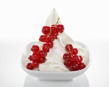 Yogurt ice cream garnished with redcurrants