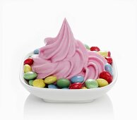 Strawberry yogurt ice cream with coloured chocolate beans