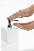 Liquid soap being pumped out of a soap dispenser