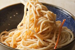 Cold Sesame Noodles in Bowl and Twirled on Chopsticks