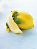 Whole lemon, lemon wedge and leaves