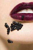 Woman with caviar on her mouth