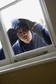 A burglar looking through a window
