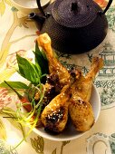 Asian chicken legs with sesame; teapot