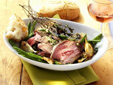 Leg of lamb with herbs, green beans and baguette