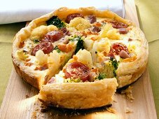 Vegetable quiche with tomatoes and cauliflower, piece cut