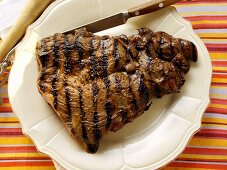 Barbecued lamb steak on plate