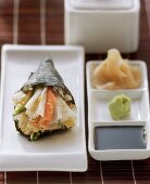 Temaki sushi with crabmeat and avocado; ginger; wasabi