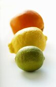 Lime, lemon and orange, one behind the other