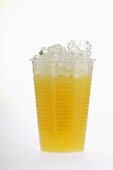 Orange juice in plastic tumbler with crushed ice