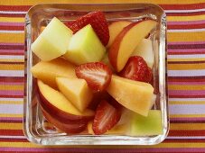 Summery fruit salad in glass bowl