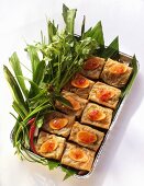 Spring rolls with carrots and herbs in aluminium dish