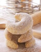 Vanilla crescents with baking utensils on chopping board