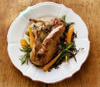 Roast legs of wild duck with herbs and carrots