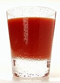 Tomato juice in glass with drops of water