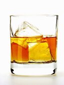 Whiskey with ice cubes in glass