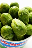 Brussels sprouts with drops of water in container