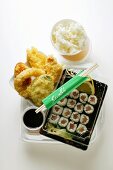 Tempura and sushi with rice and soy sauce to go
