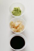 Sushi accompaniments: soy sauce, ginger and wasabi