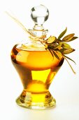 Olive oil in carafe with olive twig