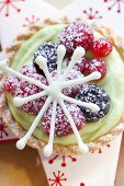 Berry tartlets with pistachio cream and chocolate star