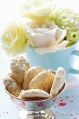 Almond macaroons in front of bouquet of flowers