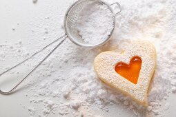 Sweet pastry heart with apricot jam and icing sugar