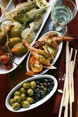 Antipasti platter, scampi and olives; grissini