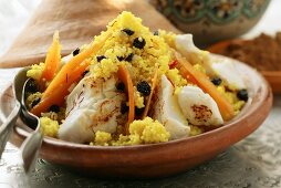 Saffron couscous with fish, carrots and raisins (N. Africa)
