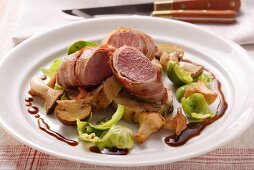 Venison fillet in bacon, forest mushrooms & Brussels sprouts