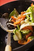 Asian vegetables with mushrooms in wok