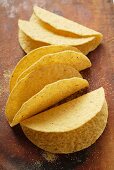 Taco shells on wooden background