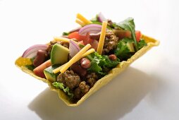Salad with mince, vegetables, cheese in taco shell (Mexico)