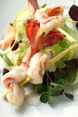Salad with shrimps skewered on lemon grass