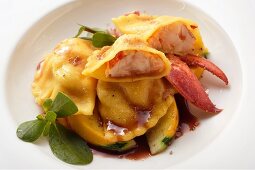 Ravioli with lobster filling on courgettes