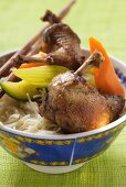 Roast pigeon with vegetables on noodles (Asia)