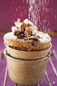 Sprinkling chocolate soufflé with icing sugar